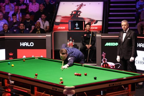 England's Shaun Murphy (C) plays a shot against China's Wu Yize (behind)