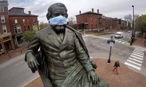 A statue of literary great Henry Wadsworth Longfellow wears a mask in Portland, Maine Monday.