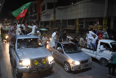 Supporters of Imran Khan ride on vehicles in a convoy in Rawalpindi.