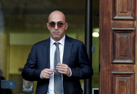 Yorgen Fenech leaving a building in suit and sunglasses