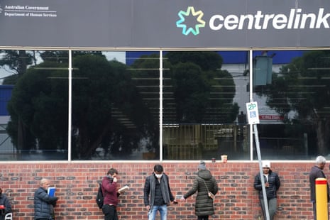 People queue outside a Centrelink office in Preston, Melbourne, Australia, 23 March 2020.