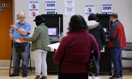 Volunteers helping voters cast their ballots at an early voting location in Maryland.