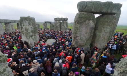 People gather in the stone circle at dawn