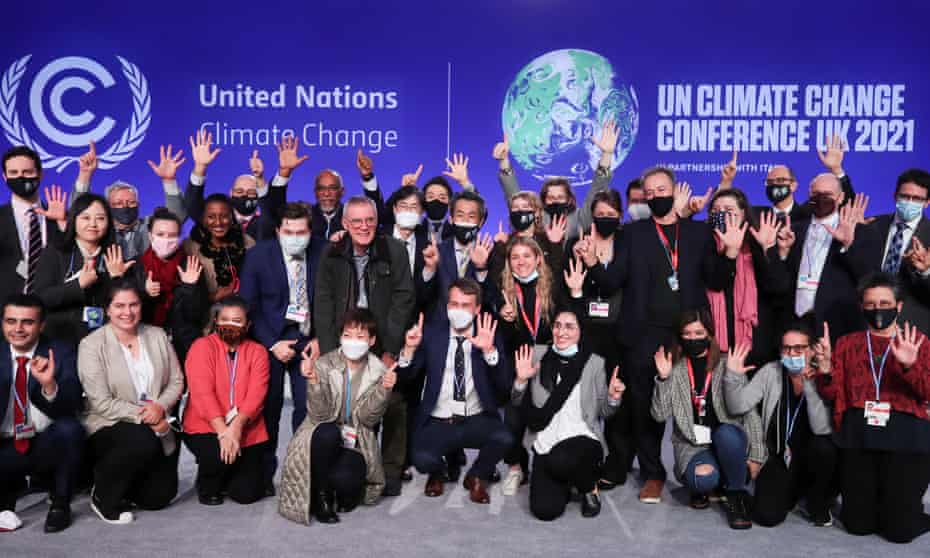 Delegates pose for a photo at the end of the Cop26 climate conference.