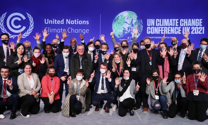 Delegates pose for a picture during the UN Climate Change Conference, COP26, in Glasgow.