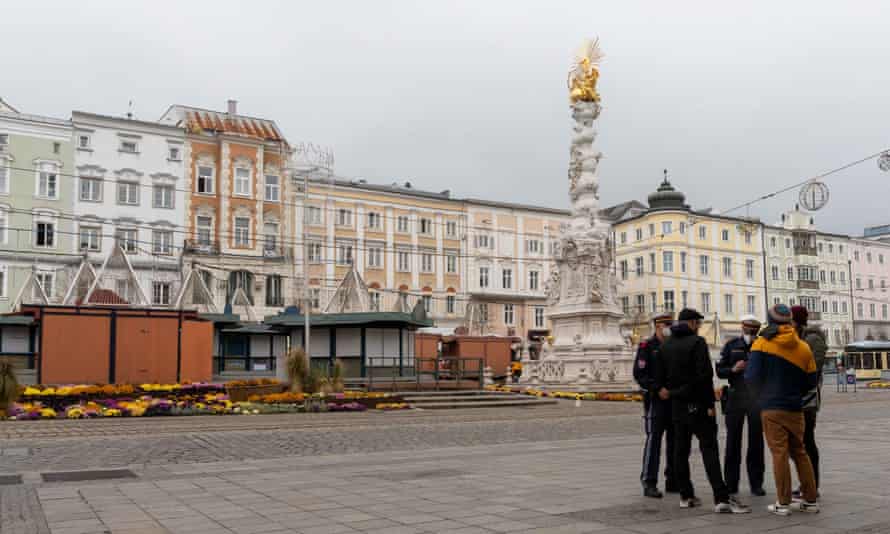 Police check people’s vaccine certificates on the streets of Linz, Austria