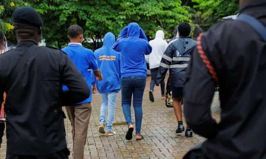 Group of people escorted out of court