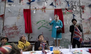 The party, held beneath the looming concrete separation wall, featured scorched union flags and bunting.