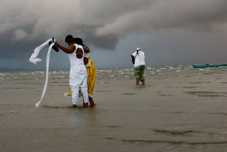 people stand on a beach
