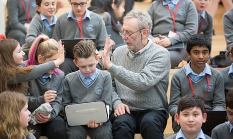 Michael Rosen surrounded by pupils