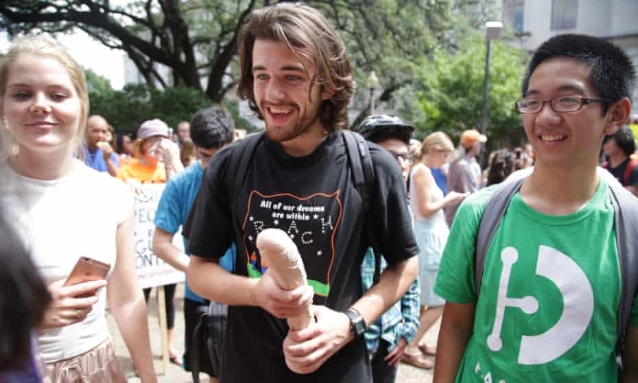 Demonstrators gathered to brandish sex toys in the air or strap them to their backpacks.