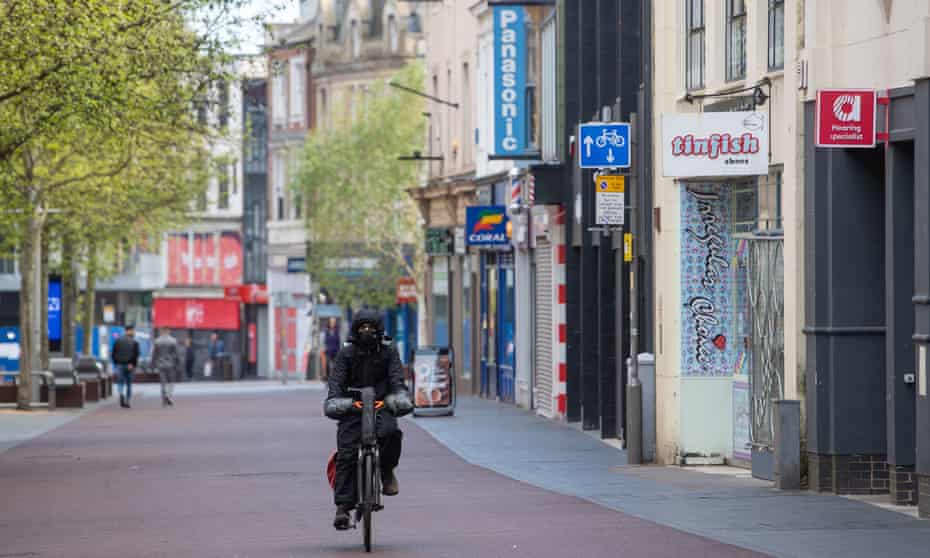 A man cycles along the High Street in Leicester