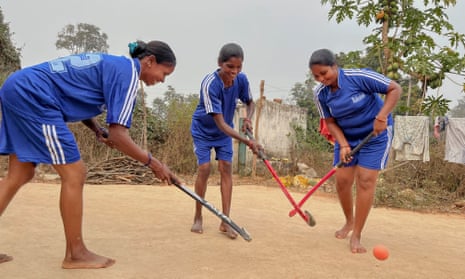 Elisaba Lakra, right, trains with her team of married women in the back yard of a house in their village.