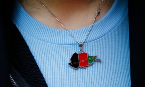 Person wearing Afghanistan flag pendant