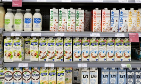Dairy-free plant-based milks in cartons and bottles on a refrigeration shelf at a Waitrose supermarket in London, England