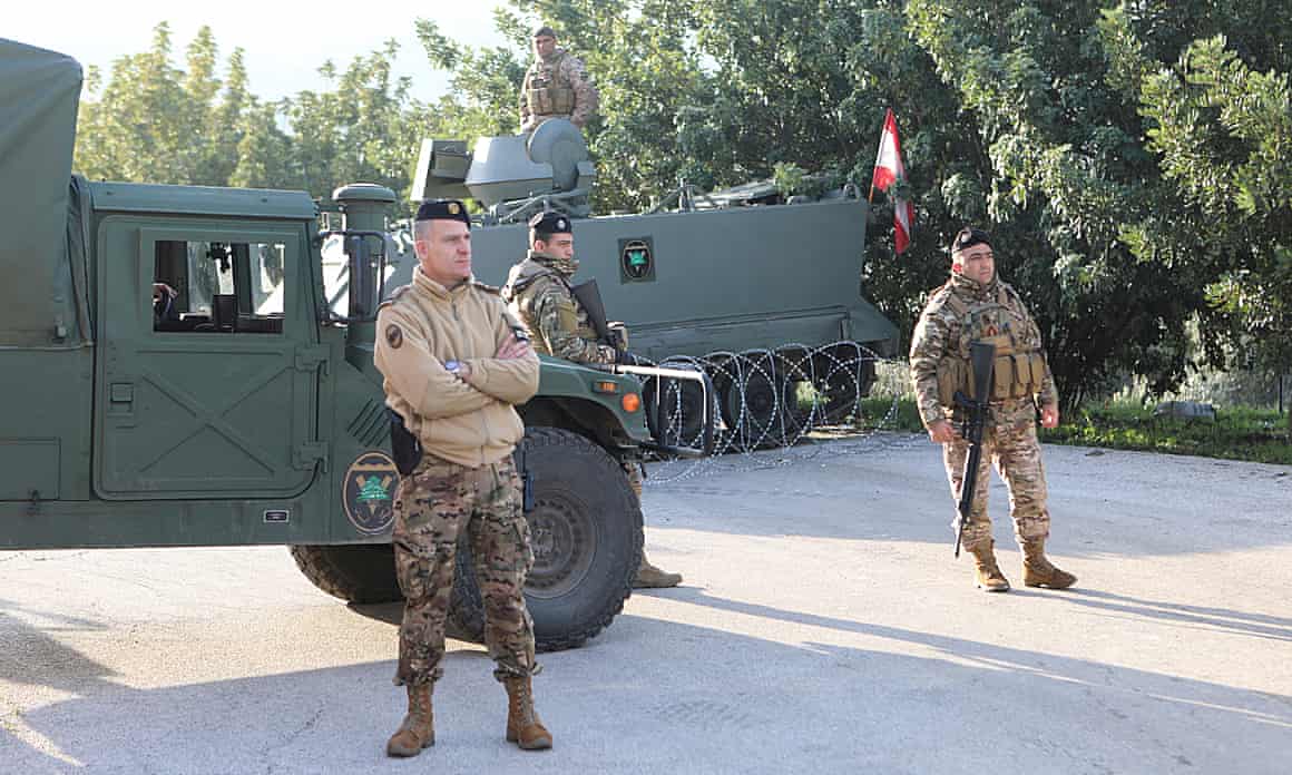 Members of the Lebanese army stand near military vehicles