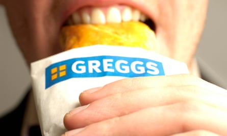 A person biting into a Greggs sausage roll.