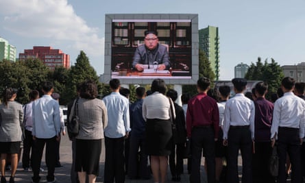 Spectators listen to Kim Jong-Un outside the central railway station in Pyongyang.