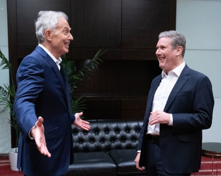 Tony Blair and Keir Starmer smile during animated conversation
