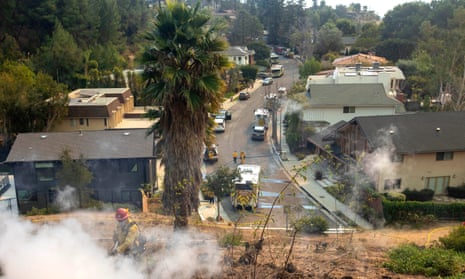Firefighters tackle blazes in the Mandeville Canyon neighbourhood in the of Brentwood area of Los Angeles during the Palisades fire.