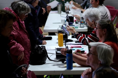 Volunteers check voters identification at the St. Anthony's Community Center during voting in the New Hampshire presidential primary election in Manchester, New Hampshire.