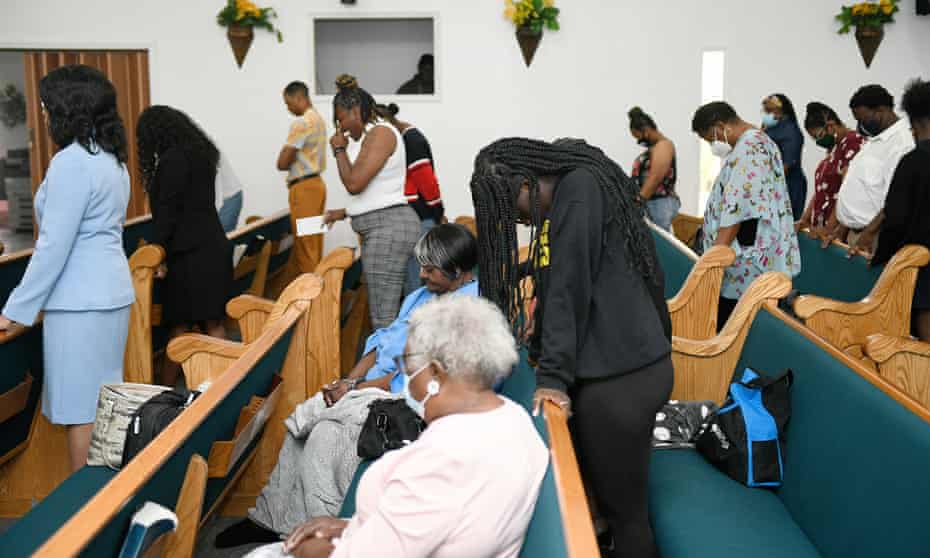 Worshipers at Bethesda Worship and Healing Center pray during the Sunday service.