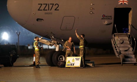 Armed forces personnel disembark an RAF aircraft at Brize Norton