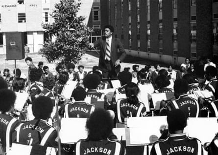 Black and white photo of a band in front of brick building