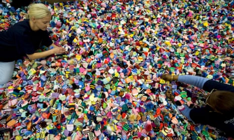 workers sort through tiny bobble hats