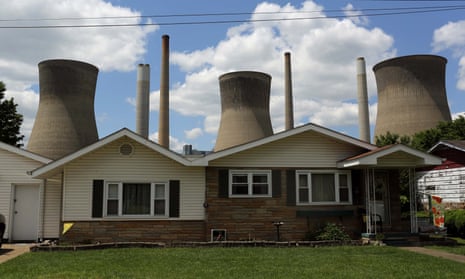 A coal-fired power plant is seen behind a home in Poca, West Virginia.