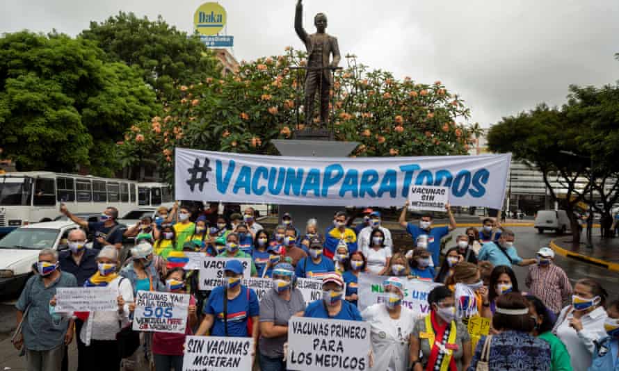 A group of people participates in a demonstration to demand a vaccination plan against Covid-19 in Caracas, Venezuela.