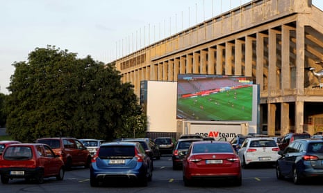 Fans watch a soccer match at a drive-in cinema in Prague.
