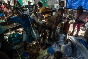 Cholera patients lie on the floor of a small clinic in Rendel, Haiti