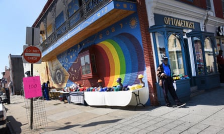 Shoppers pick from a colourful hat collection along Baltimore’s Monument Street shopping district.