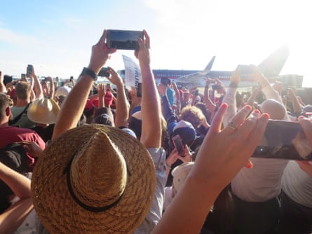 The crowd greets Trump’s plane on its arrival at the rally