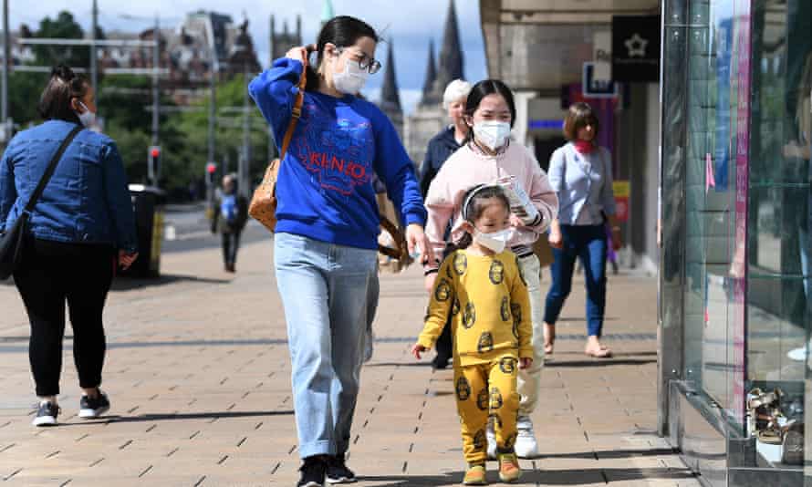 Members of the public wear face masks as they shop on Princes Street