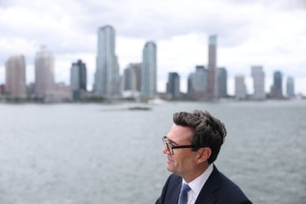 Andy Burnham smiling in front of a New York skyline
