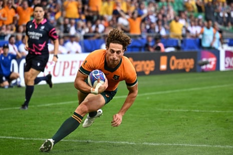 Australia's right wing Mark Nawaqanitawase dives for the line.