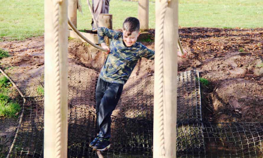 Young boy on an obstacle course at the Bear Trail, Devon.