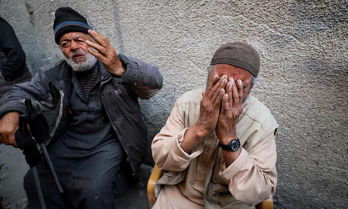 Palestinians react at the site of an Israeli strike on a residential building in Jabalia in the northern Gaza Strip