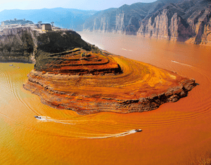Yellow river, ChinaThis is the third-longest river in Asia, and the most silt-laden river on Earth. It takes its name from coloration by the fine, wind-blown sediment, known as loess, that it carries along its lower course. The river flows through deep gorges, as seen in the image, before it descends on to the North China Plain.