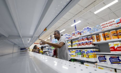 Hurricane Irma preparations in Miami Beach, Florida, USA<br>epaselect epa06190699 A shopper searches the sparse water shelves at the Presidente Supermarket in the Little Haiti neighborhood ahead of the expected arrival of Hurricane Irma in Miami, Florida, USA, 07 September 2017. Miami Beach, the Florida Keys and other low-lying areas are under a mandatory evacuation order ahead of Irma.  EPA/ERIK S. LESSER