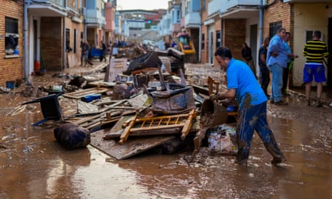 A man cleans his house affected by floods in Utiel, Spain, Wednesday, Oct. 30, 2024. (AP Photo/Manu Fernandez)