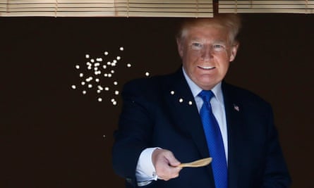 US President Donald Trump feeds carps with Japan’s Prime Minister Shinzo Abe before their working lunch.