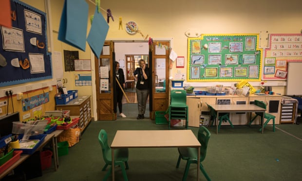 The headteacher and a teaching assistant work to provide a safe class environment at a school near Huddersfield.