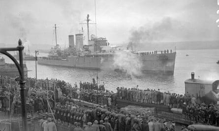 HMS Exeter coming alongside at Plymouth in February 1940 watched by a crowd.