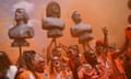 Netherlands fans march to the game along with busts of Johan Cruyff (left), Ruud Gullit (centre) and Dennis Bergkamp.