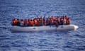 A group of people on a raft in the Mediterranean.