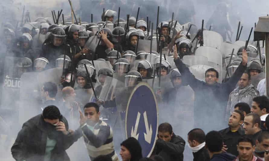 Anti-government activists clash with riot police in Cairo in January 2011.