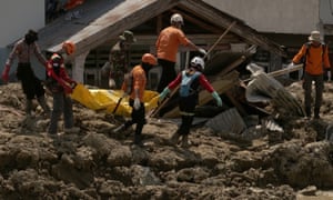 Rescuers carry away the body of a victim in Palu, Central Sulawesi, Indonesia, on Wednesday after last monthâs earthquake and tsunami.